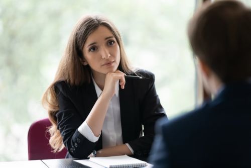 Engaged attorney talking to client in interview. Client consulting lawyer in office concept.